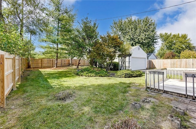 106 Mark Ct, Germantown, OH 45327 - fenced backyard with a wooden deck, an outdoor structure, and a detached garage