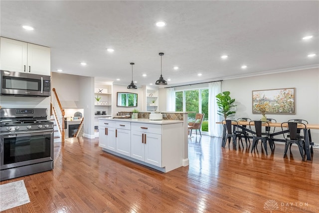 4629 Wicklow Dr, Middletown, OH 45042 - kitchen with appliances with stainless steel finishes, white cabinets, recessed lighting, light wood-type flooring, and decorative light fixtures