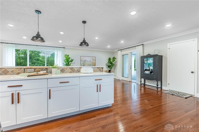 4629 Wicklow Dr, Middletown, OH 45042 - kitchen featuring ornamental molding, healthy amount of natural light, light countertops, hanging light fixtures, and decorative backsplash