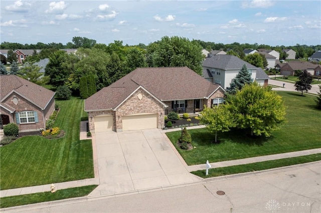 1210 Greystone Cir, Dayton, OH 45414 - view of front of property with an attached garage, a porch, driveway, a front yard, and stone siding
