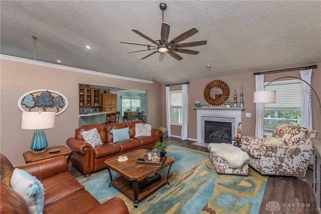 1210 Greystone Cir, Dayton, OH 45414 - living room with ceiling fan, wood finished floors, a textured ceiling, a fireplace with flush hearth, and healthy amount of natural light
