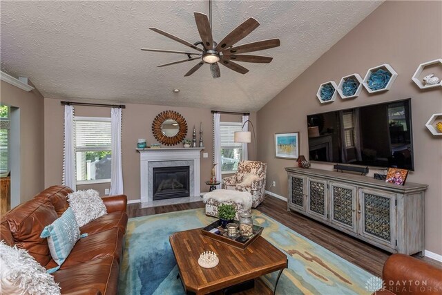1210 Greystone Cir, Dayton, OH 45414 - living area with a fireplace with flush hearth, a textured ceiling, ceiling fan, wood finished floors, and vaulted ceiling