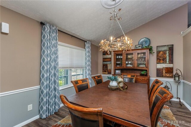 1210 Greystone Cir, Dayton, OH 45414 - dining room featuring a chandelier, lofted ceiling, dark wood-style flooring, and a textured ceiling