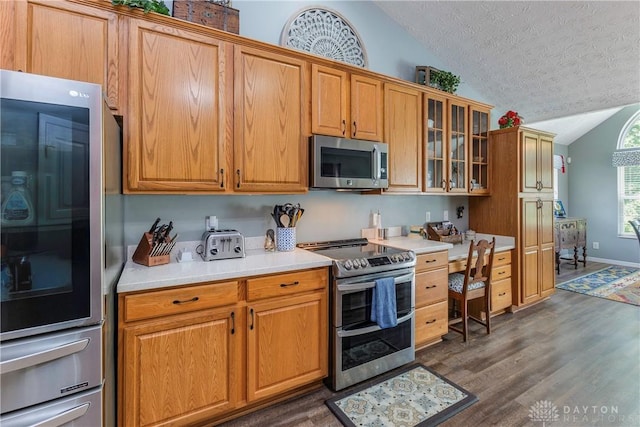 1210 Greystone Cir, Dayton, OH 45414 - kitchen featuring stainless steel appliances, lofted ceiling, a textured ceiling, dark wood-style floors, and light countertops