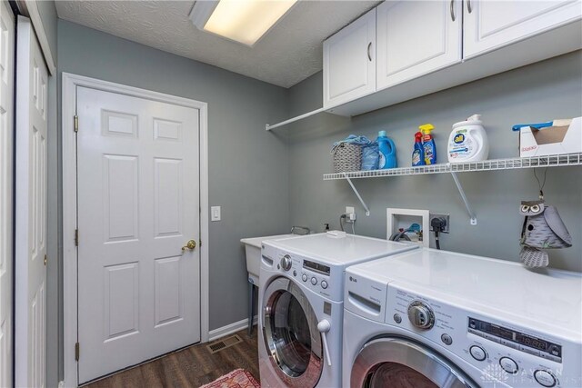 1210 Greystone Cir, Dayton, OH 45414 - laundry area featuring washing machine and clothes dryer, cabinet space, and dark wood finished floors