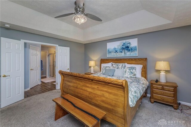 1210 Greystone Cir, Dayton, OH 45414 - bedroom featuring carpet flooring, a tray ceiling, a ceiling fan, and a textured ceiling