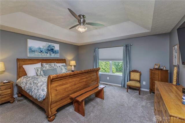 1210 Greystone Cir, Dayton, OH 45414 - carpeted bedroom featuring a raised ceiling, a textured ceiling, and a ceiling fan