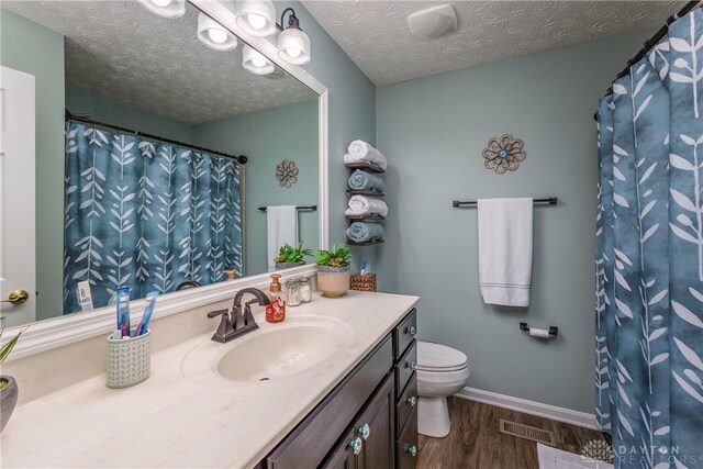 1210 Greystone Cir, Dayton, OH 45414 - bathroom featuring vanity, wood finished floors, and a textured ceiling