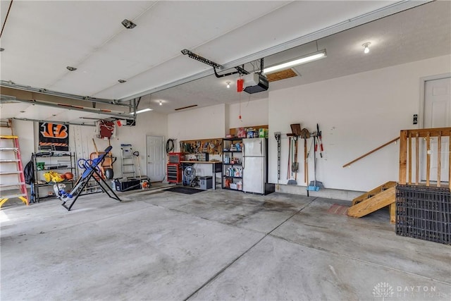 1210 Greystone Cir, Dayton, OH 45414 - garage with freestanding refrigerator and a garage door opener