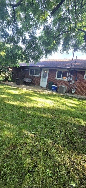 5012 Neyer Ct, Huber Heights, OH 45424 - rear view of house featuring brick siding, a yard, and a patio area