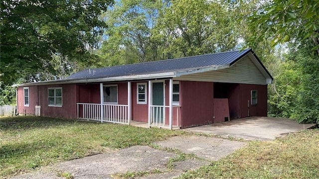 471 Camden W Elkton Rd, Camden, OH 45311 - view of front of property featuring covered porch, a metal roof, driveway, and view of wooded area