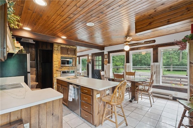 8760 State Route 380, Chester Twp, OH 45177 - kitchen featuring wood ceiling, light tile patterned floors, light countertops, appliances with stainless steel finishes, and brown cabinetry