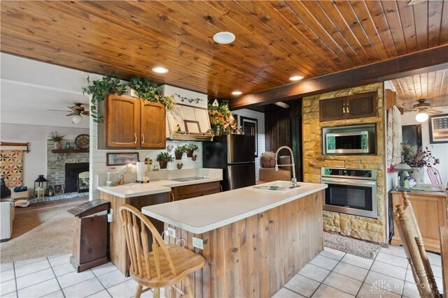 8760 State Route 380, Chester Twp, OH 45177 - kitchen with stainless steel appliances, a ceiling fan, light tile patterned floors, light countertops, and wooden ceiling