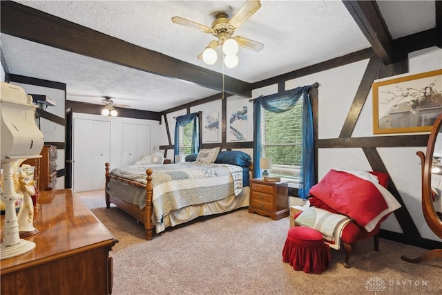 8760 State Route 380, Chester Twp, OH 45177 - carpeted bedroom featuring a textured ceiling, beam ceiling, ceiling fan, and two closets