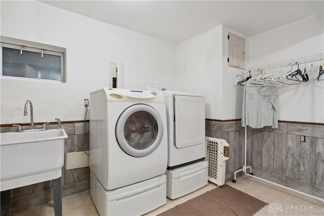 8760 State Route 380, Chester Twp, OH 45177 - laundry room featuring washing machine and clothes dryer, tile walls, wainscoting, and light tile patterned flooring