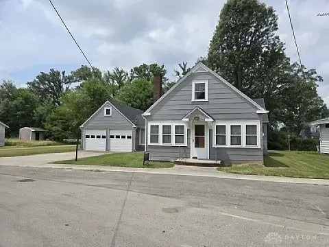 391 N Oak St, Lakeview, OH 43331 - bungalow-style home with a garage, a chimney, and a front yard