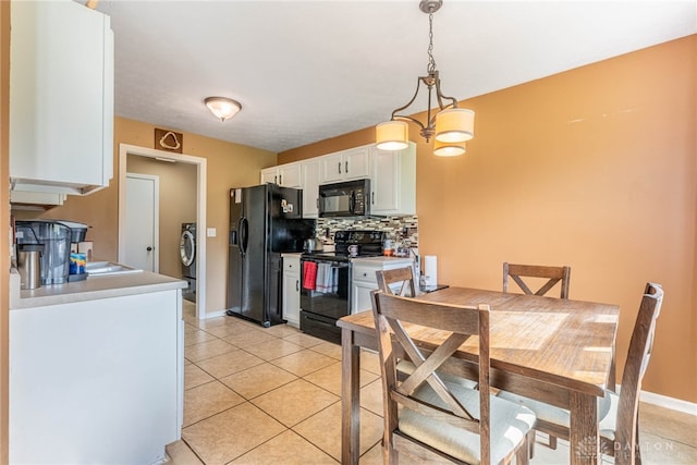 7502 Ned Ct, Franklin, OH 45005 - kitchen with black appliances, white cabinets, backsplash, light tile patterned floors, and washer / dryer