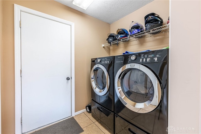 7502 Ned Ct, Franklin, OH 45005 - washroom with light tile patterned floors, washing machine and clothes dryer, and a textured ceiling