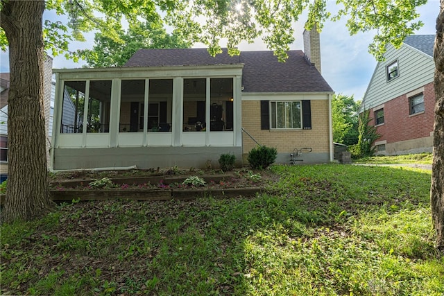 2311 Alpine Way, Dayton, OH 45406 - view of front facade with brick siding, a sunroom, a chimney, and roof with shingles