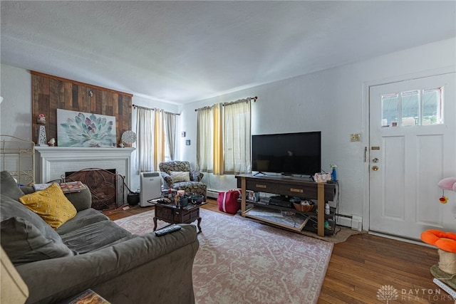 2311 Alpine Way, Dayton, OH 45406 - living area featuring wood finished floors, a fireplace, and a baseboard radiator