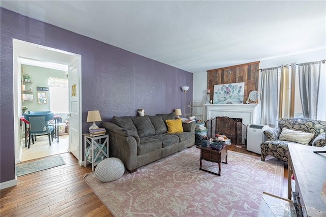 2311 Alpine Way, Dayton, OH 45406 - living room with wood-type flooring, a textured wall, and a fireplace