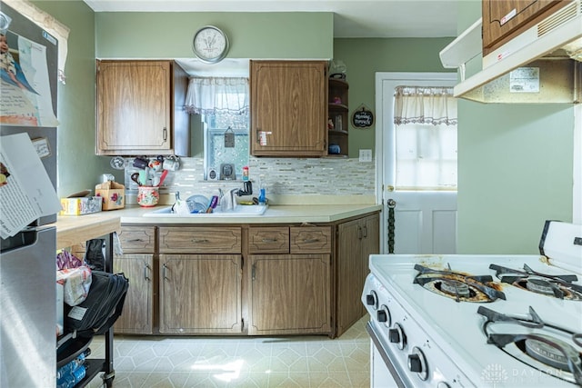 2311 Alpine Way, Dayton, OH 45406 - kitchen featuring white range with gas stovetop, under cabinet range hood, freestanding refrigerator, open shelves, and light countertops