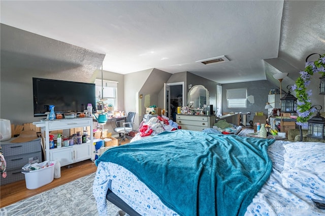 2311 Alpine Way, Dayton, OH 45406 - bedroom with wood finished floors, lofted ceiling, and a textured ceiling