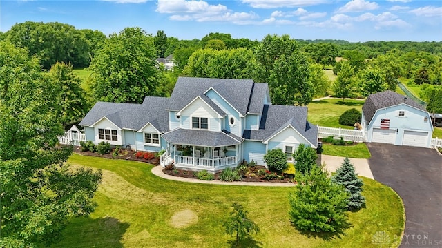 3244 N Shoemaker Rd, Lebanon, OH 45036 - victorian-style house featuring an outbuilding, roof with shingles, covered porch, a garage, and driveway