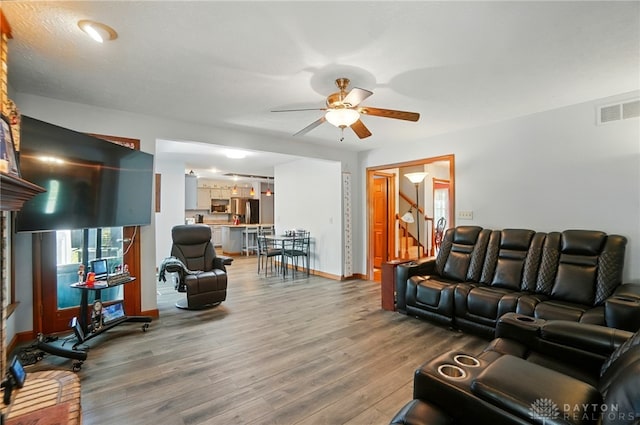 3244 N Shoemaker Rd, Lebanon, OH 45036 - living area featuring a ceiling fan, wood finished floors, and stairway