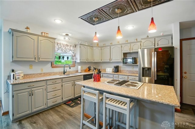 3244 N Shoemaker Rd, Lebanon, OH 45036 - kitchen with black appliances, a kitchen breakfast bar, hanging light fixtures, and dark wood-type flooring