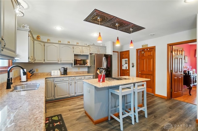 3244 N Shoemaker Rd, Lebanon, OH 45036 - kitchen with appliances with stainless steel finishes, dark wood-style flooring, a kitchen island, a kitchen bar, and decorative light fixtures