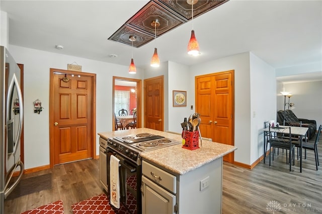 3244 N Shoemaker Rd, Lebanon, OH 45036 - kitchen featuring range with electric stovetop, stainless steel fridge with ice dispenser, dark wood-style floors, pendant lighting, and light countertops