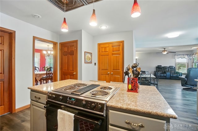 3244 N Shoemaker Rd, Lebanon, OH 45036 - kitchen with electric stove, dark wood-type flooring, a ceiling fan, a chandelier, and hanging light fixtures