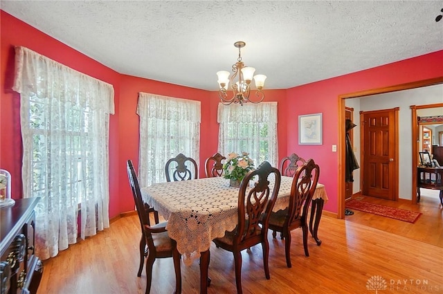 3244 N Shoemaker Rd, Lebanon, OH 45036 - dining space featuring a chandelier, light wood-style floors, and a textured ceiling