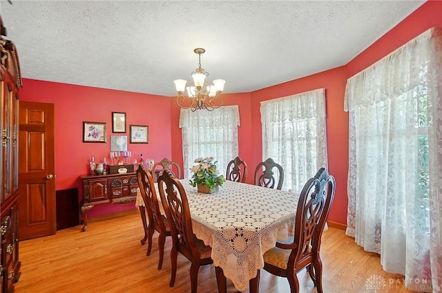 3244 N Shoemaker Rd, Lebanon, OH 45036 - dining area with a chandelier, light wood finished floors, and a textured ceiling