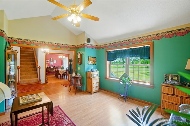 3244 N Shoemaker Rd, Lebanon, OH 45036 - living room with vaulted ceiling, stairway, a chandelier, ceiling fan, and wood finished floors