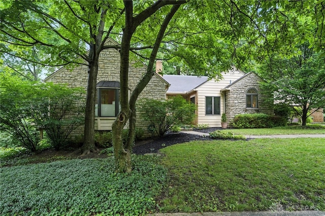 1314 Red Bud Trl, Dayton, OH 45409 - view of front of property featuring stone siding, a front lawn, and a chimney