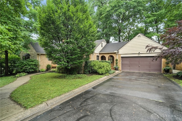 1314 Red Bud Trl, Dayton, OH 45409 - view of front of house with brick siding, asphalt driveway, and a garage
