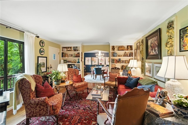 1314 Red Bud Trl, Dayton, OH 45409 - sitting room featuring a chandelier, built in shelves, crown molding, wood finished floors, and arched walkways