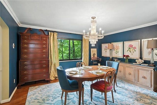 1314 Red Bud Trl, Dayton, OH 45409 - dining space featuring a chandelier, wood finished floors, crown molding, and arched walkways