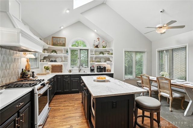 1314 Red Bud Trl, Dayton, OH 45409 - kitchen with gas range gas stove, open shelves, a kitchen bar, high vaulted ceiling, and dark cabinetry