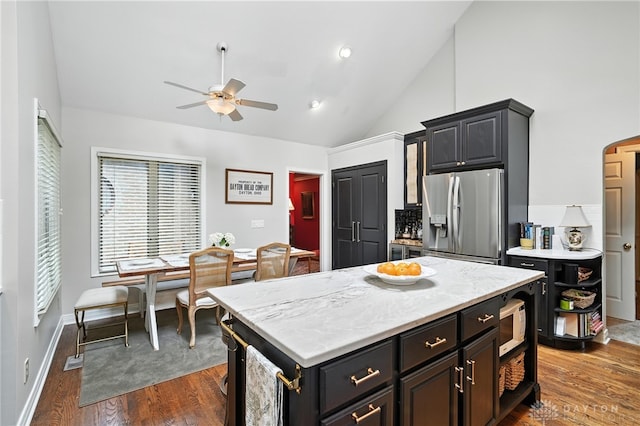 1314 Red Bud Trl, Dayton, OH 45409 - kitchen with stainless steel refrigerator with ice dispenser, ceiling fan, white microwave, dark wood-type flooring, and high vaulted ceiling