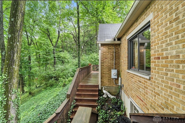 1314 Red Bud Trl, Dayton, OH 45409 - view of side of home with brick siding, a deck, and stairway