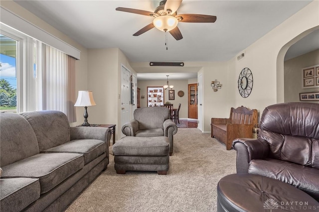 6977 Alternate State Route 49, Arcanum, OH 45304 - carpeted living room with plenty of natural light, arched walkways, a chandelier, and ceiling fan