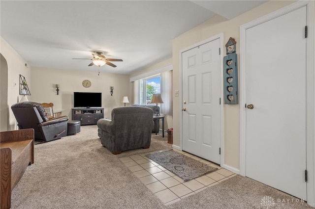 6977 Alternate State Route 49, Arcanum, OH 45304 - carpeted living area with a ceiling fan, arched walkways, and tile patterned floors