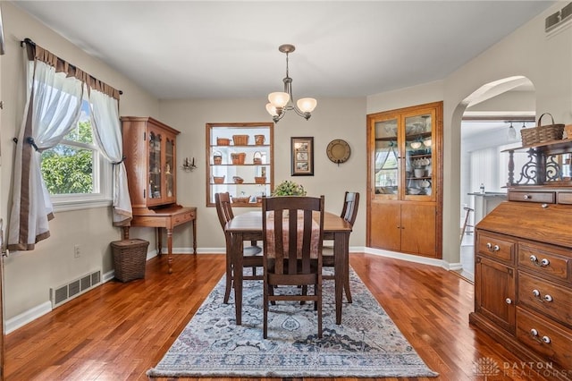 6977 Alternate State Route 49, Arcanum, OH 45304 - dining room with wood finished floors, arched walkways, and a chandelier