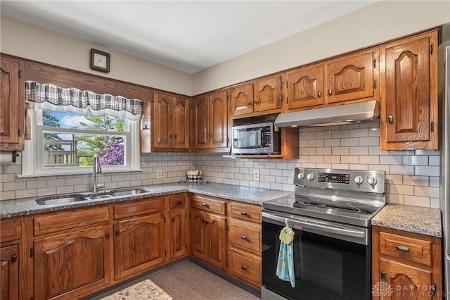 6977 Alternate State Route 49, Arcanum, OH 45304 - kitchen featuring stainless steel appliances, under cabinet range hood, brown cabinets, and backsplash
