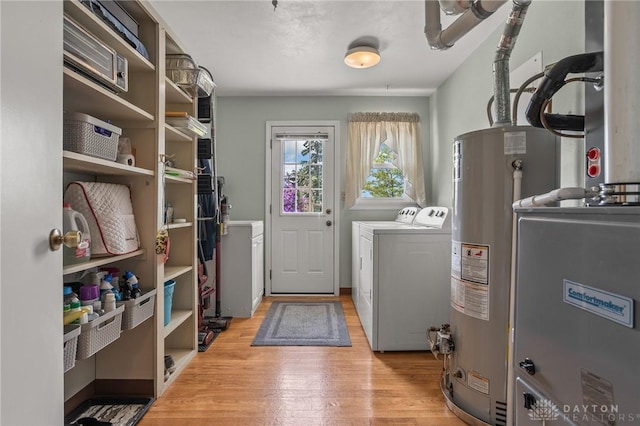 6977 Alternate State Route 49, Arcanum, OH 45304 - laundry area with washing machine and dryer, light wood-type flooring, and gas water heater