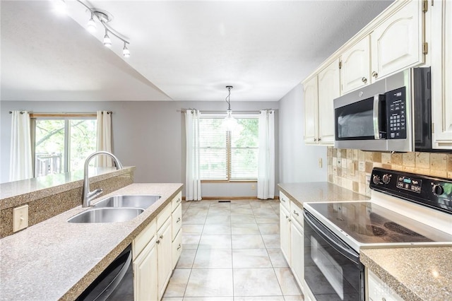 6437 Sun Ridge Dr, Waynesville, OH 45068 - kitchen with electric stove, stainless steel microwave, plenty of natural light, and light countertops