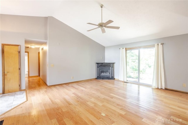 6437 Sun Ridge Dr, Waynesville, OH 45068 - unfurnished living room featuring high vaulted ceiling, a ceiling fan, and light wood-style floors